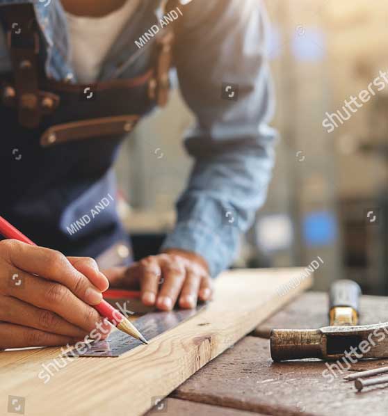 A woodworker measuring wood