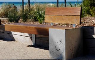 A wooden bench by the beach