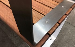 Metal screwed to a wooden bench