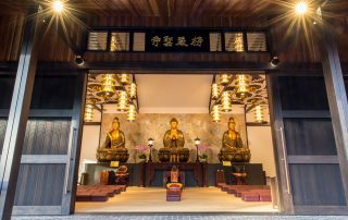A Chinese temple with three Buddha statues